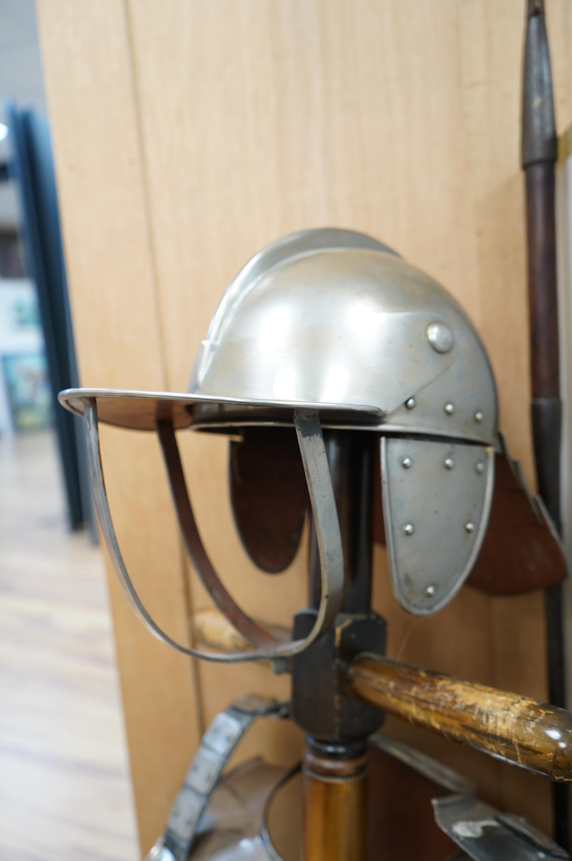 A replica suit of English Civil War armour on a stand, comprising; a lobster pot helmet, breastplate and back plate. Condition - poor to fair